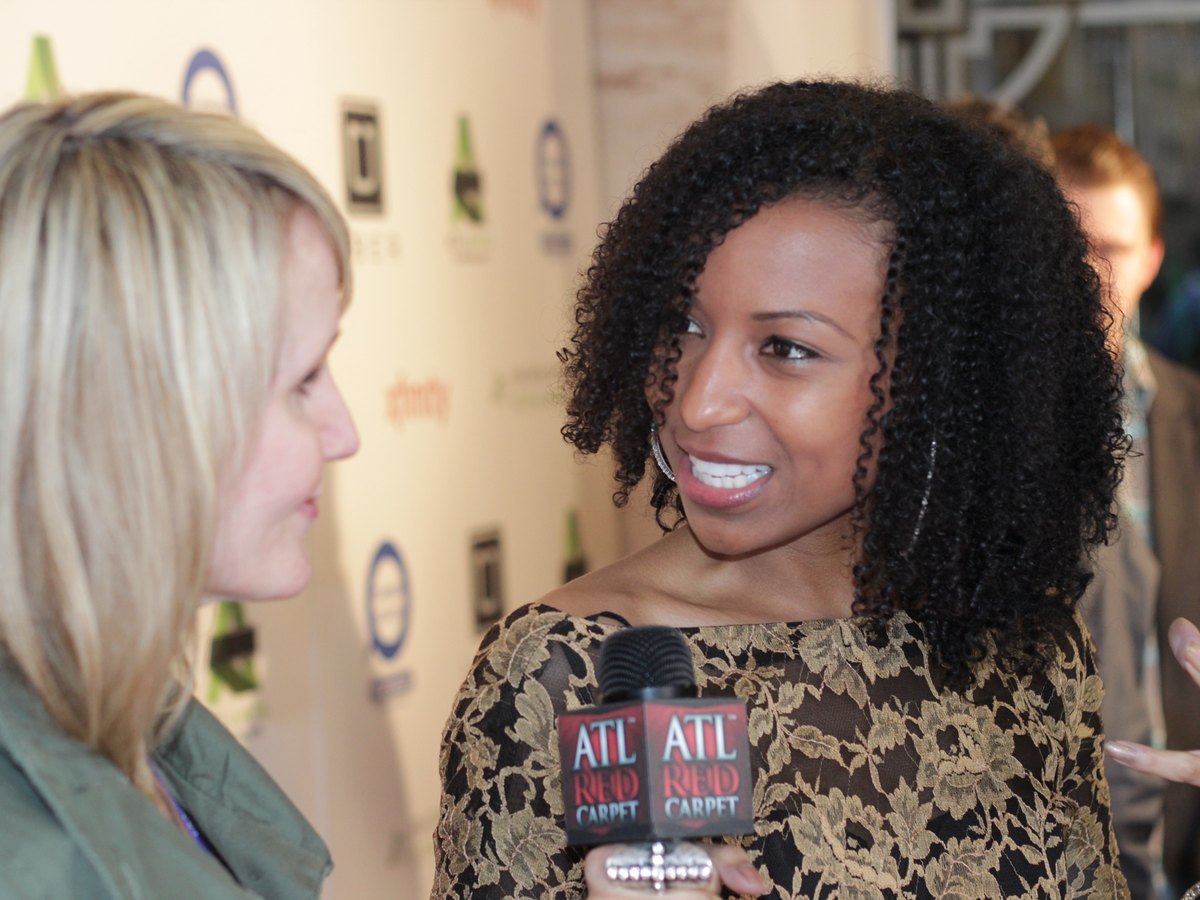 Chelsea interviewing a guest with an ATL Red Carpet mic at the Atlanta Film Festival