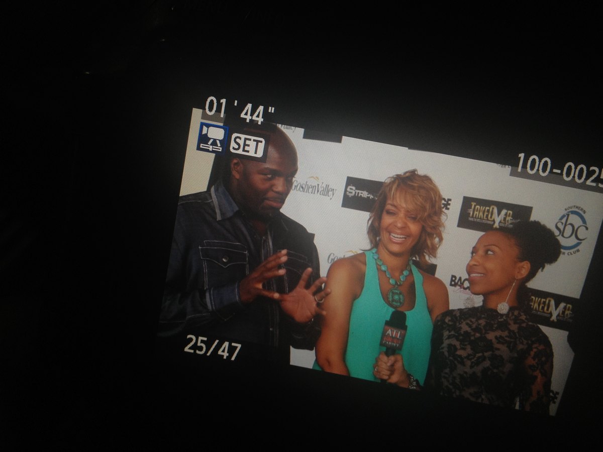 A camera screen framing Chelsea's red carpet interview at the STRIPPED opening night