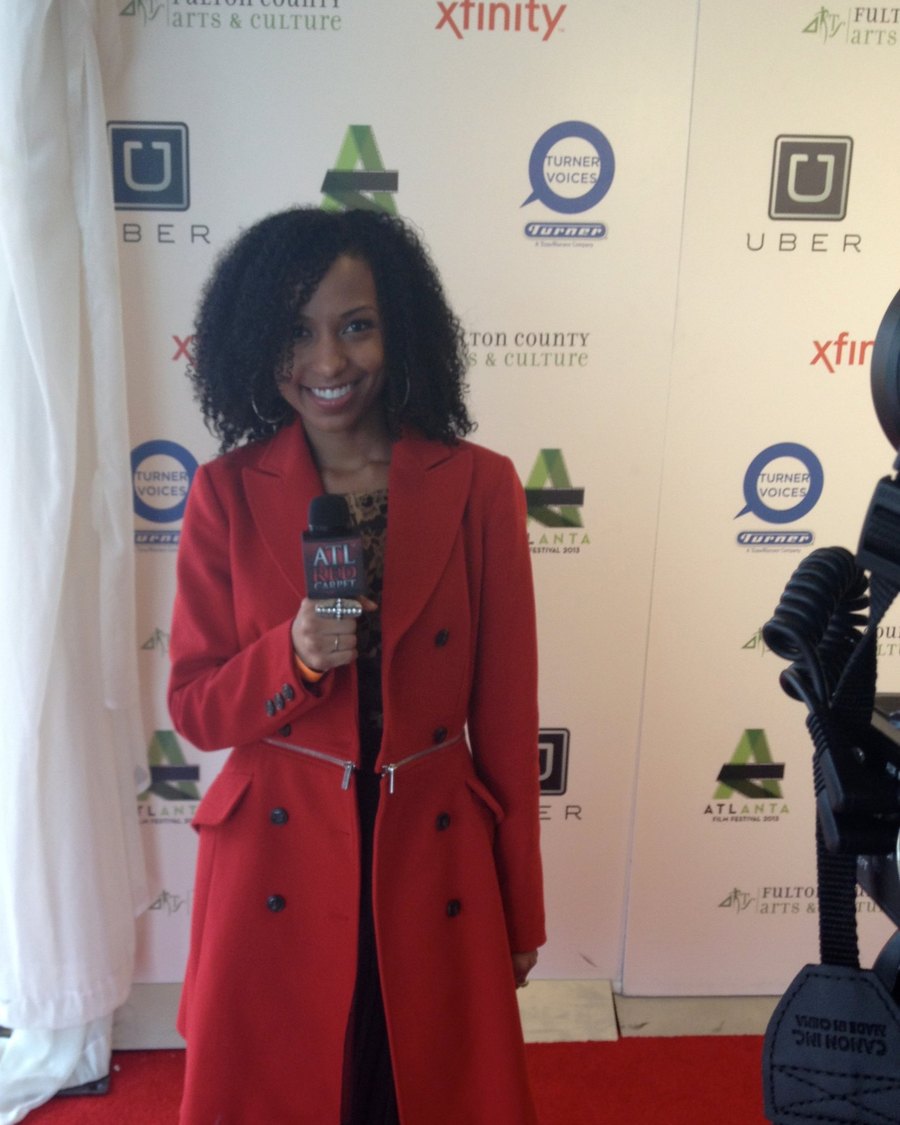 Chelsea in a red coat with an ATL Red Carpet mic on the Atlanta Film Festival 2013 red carpet