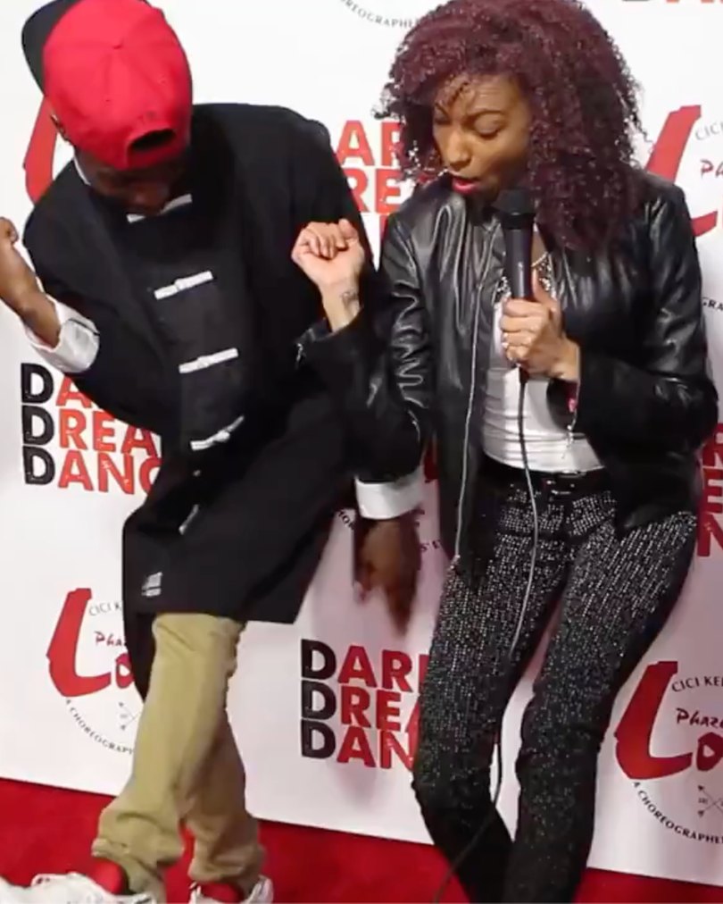Chelsea dancing with a guest on the Phazes of Love red carpet