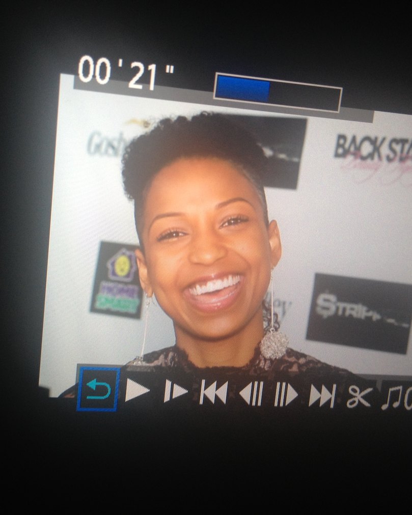 Chelsea laughing on a camera screen at the STRIPPED opening night red carpet